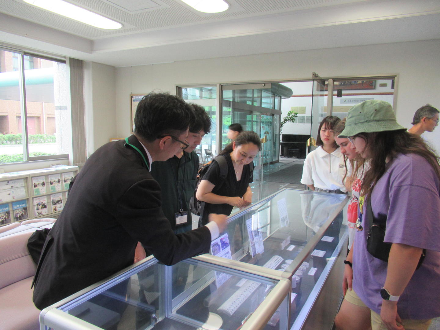 Rebun Kayo (on the left) describing the exhibition of his research. 