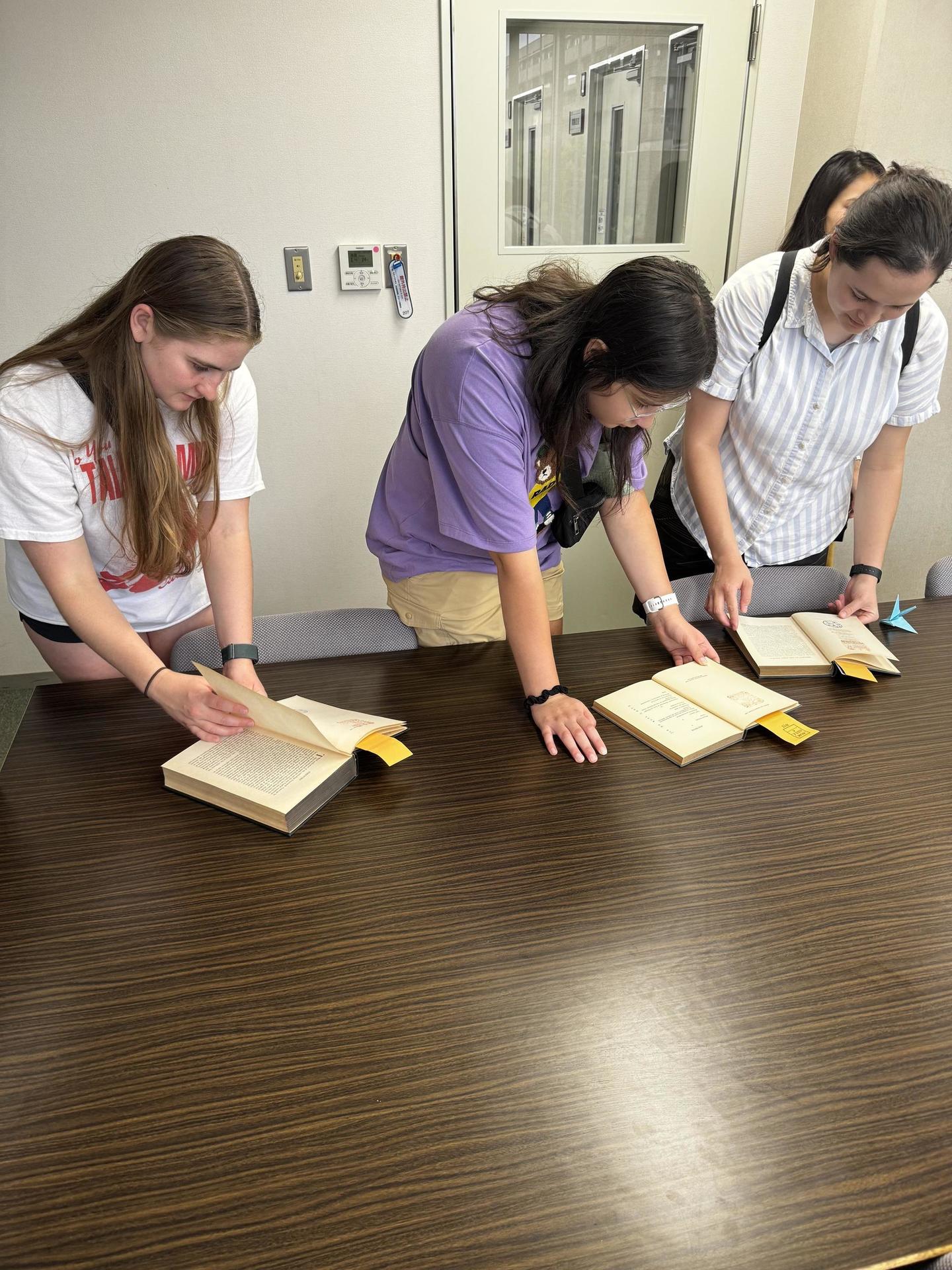 The NP researchers investigating the books.